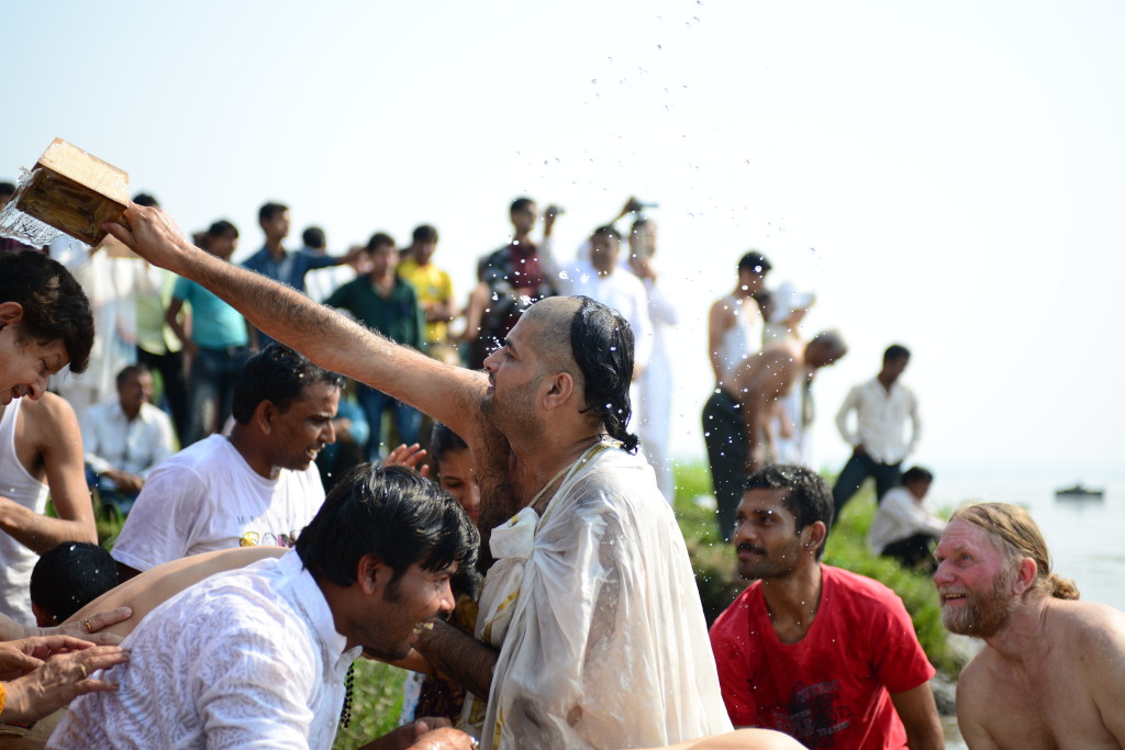 Achal douses participants with water from the Narmada.